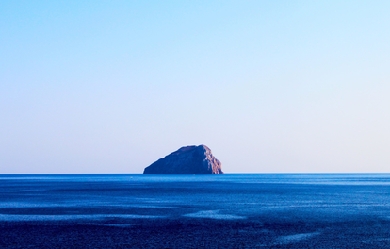 Rock island in the middle of the blue sea