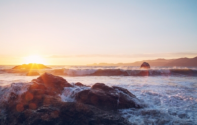 Sunrise by the sea. Waves and rocks.